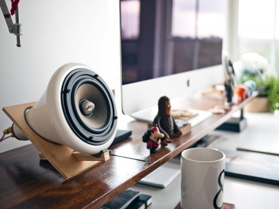 Compact home audio speaker on a desk