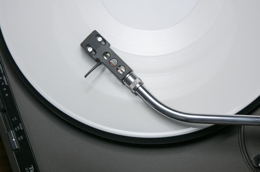 Turntable tonearm resting on a vinyl record
